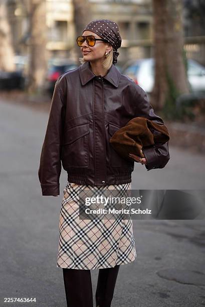 Julia Kammerer is seen wearing a dark brown leather aviator jacket with classic collar, zip front, flap pockets and slightly oversized fit from H&M;...
