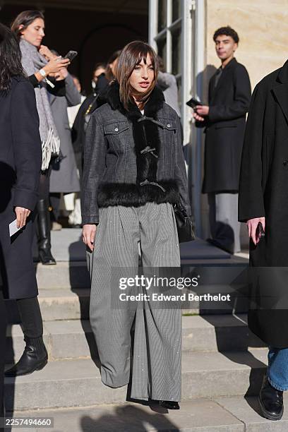 Guest wears straight medium-length brown hair with bangs, a black leather handheld bag, a gray charcoal denim jacket trimmed with black faux fur at...