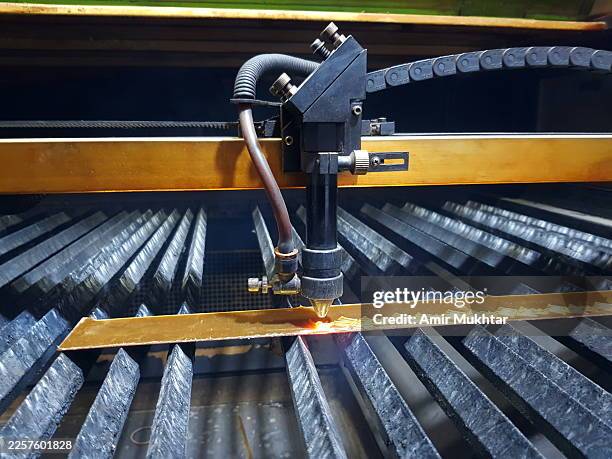 laser machine engraving and cutting alphabets from plastic sheet. - laser engraving stock pictures, royalty-free photos & images