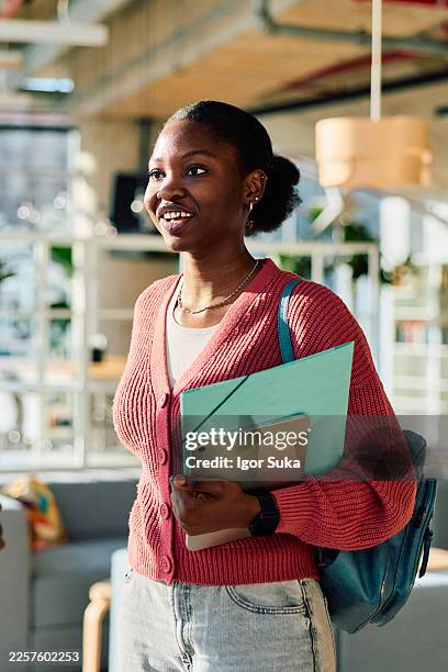 female student smiling holding tablet and folder on campus - knowledge is power stock pictures, royalty-free photos & images