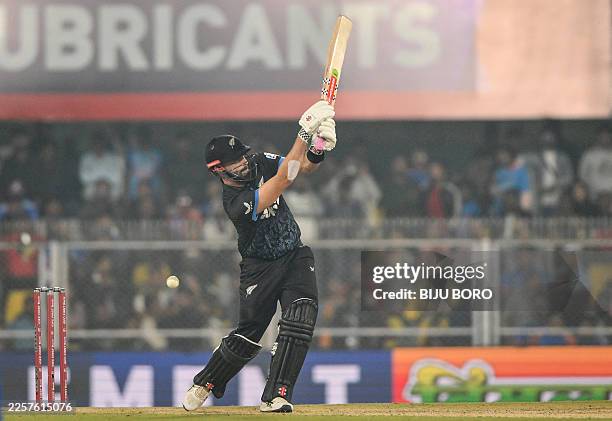 New Zealand's Daryl Mitchell plays a shot during the third Twenty20 international cricket match between India and New Zealand at the Barsapara...