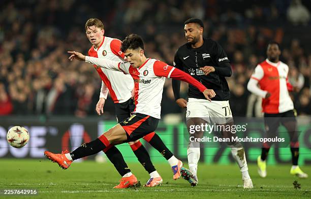 Tsuyoshi Watanabe of Feyenoord clears the ball whilst under pressure from Maurice Malone of SK Sturm Graz during the UEFA Europa League 2025/26...