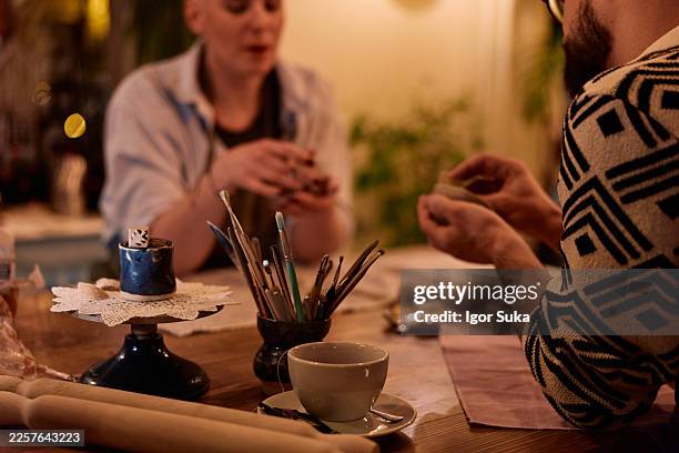 people taking pottery class, shaping clay - art and craft stock pictures, royalty-free photos & images