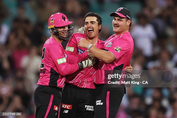 Joel Davies of the Sixers celebrates with team mates after taking the wicket of Matthew Wade of the Hurricanes during the BBL Challenger match...