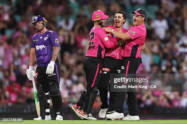 Joel Davies of the Sixers celebrates with team mates after taking the wicket of Matthew Wade of the Hurricanes during the BBL Challenger match...