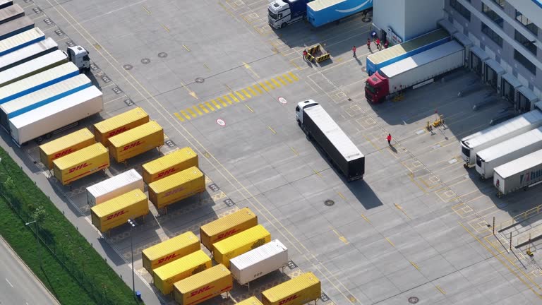 https://media.gettyimages.com/id/2257789392/video/aerial-view-of-a-logistics-center-with-trucks-and-containers-parked.jpg?b=1&s=640x640&k=20&c=wNX9qNxB2Kz7p7R2S1-TqjYDOyjKK_uDfN_rPJSNTxQ=