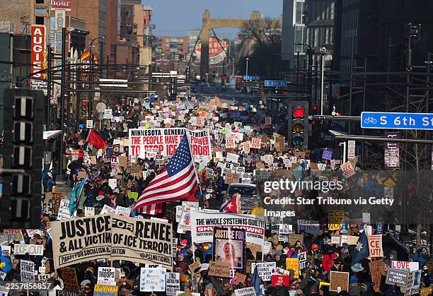 In sub-zero temperatures, marchers in downtown Minneapolis, Minn., on Friday, January 23 waved signs decrying ongoing immigration enforcement...