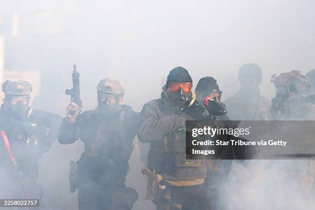 Federal agents attempt to control a growing crowd on Nicollet Avenue in south Minneapolis after Alex Pretti was fatally shot by federal agents in the...