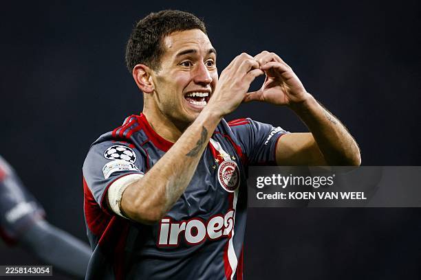 Olympiakos' Argentine midfielder Santiago Hezze celebrates after scoring Olympiakos' second goal during the UEFA Champions League, league phase -...
