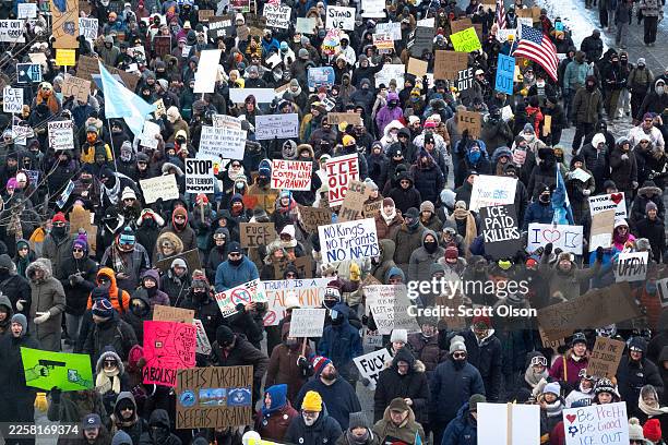 Demonstrators march through downtown protesting ICE operations and the death of Renee Good and Alex Pretti on January 25, 2026 in Minneapolis,...