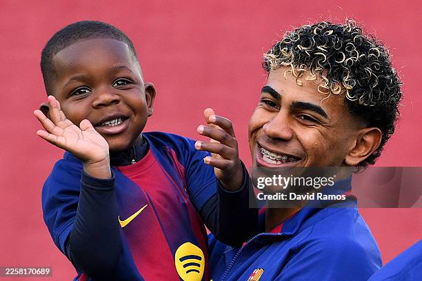 Lamine Yamal of FC Barcelona interacts with his half brother Keyne Yamal on the pitch prior to the LaLiga EA Sports match between FC Barcelona and...