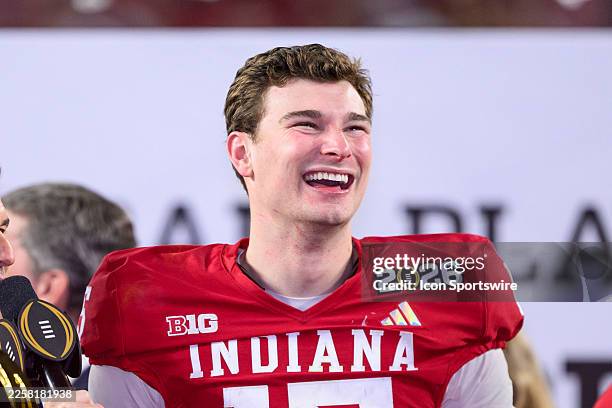 Fernando Mendoza of the Indiana Hoosiers smiles on the trophy stage after the Indiana Hoosiers versus the Miami Hurricanes College Football Playoff...