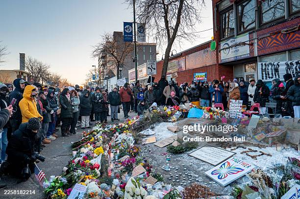 People pay their respects at a memorial site for Alex Pretti on January 25, 2026 in Minneapolis, Minnesota. Pretti was shot and killed by federal...
