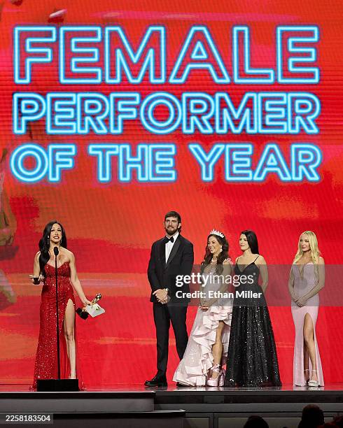 Jennifer White accepts the Female Performer of the Year award as presenters Girthmasterr, Cherie DeVille and Adriana Chechik, and trophy girl Meagan...