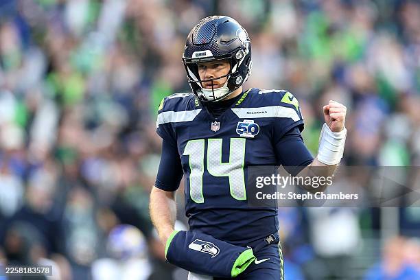 Sam Darnold of the Seattle Seahawks celebrates a first quarter touchdown against the Los Angeles Rams in the NFC Championship game at Lumen Field on...