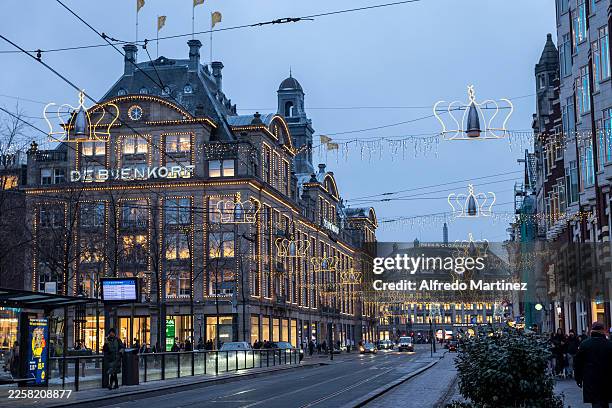 View of the De Bijenkorf department store in Amsterdam, illuminated with Christmas lights on January 11, 2026 in Amsterdam, Netherlands.