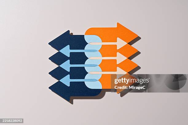 two opposing arrow groups connecting through overlap, paper craft - side by side stock pictures, royalty-free photos & images