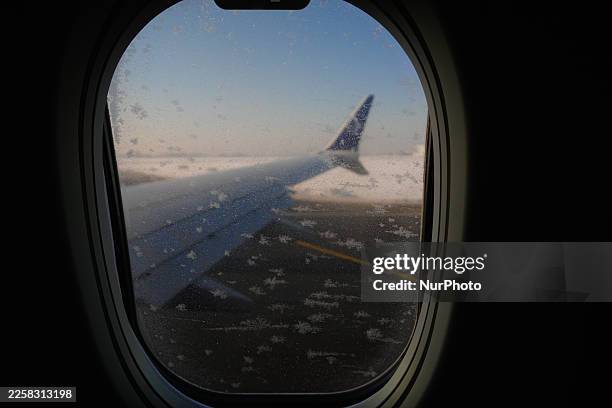 Ice crystals are seen on the window of a Boeing 737 in Warsaw, Poland on 21 January, 2026.