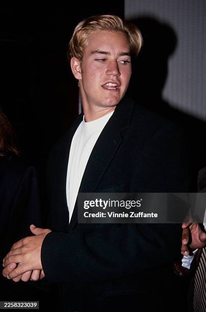 American actor Mark-Paul Gosselaar wearing a black suit jacket over a white crew neck shirt, United States, circa 1993.