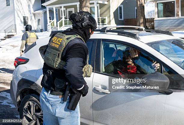 Member of the U.S. Border Patrol confronts the passenger of a vehicle that was following them on January 29, 2026 in Minneapolis, Minnesota. Protests...
