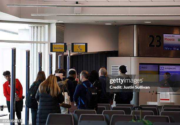 Southwest Airlines line up to board a flight at Oakland San Francisco Bay Airport on January 26, 2026 in Oakland, California. Southwest Airlines will...