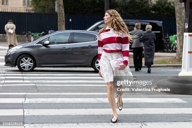 Veronika Heilbrunner wears a red-and-pale-pink horizontal striped long-sleeve polo-style knit tucked into a white embroidered tulle skirt with floral...