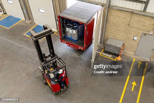 forklift moving industrial merchandise at a distribution warehouse - loading dock stock pictures, royalty-free photos & images