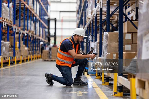 warehouse employee taking inventory of packages using a bar code reader - input device stock pictures, royalty-free photos & images