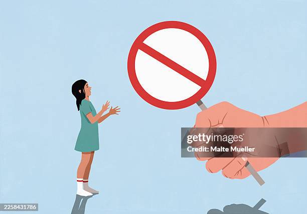 large fist holding do not enter sign in front of surprised girl gesturing on blue background - exclusion stock illustrations
