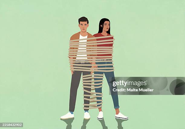 suspicious couple strapped together with rope against green background - relationship difficulties stock illustrations
