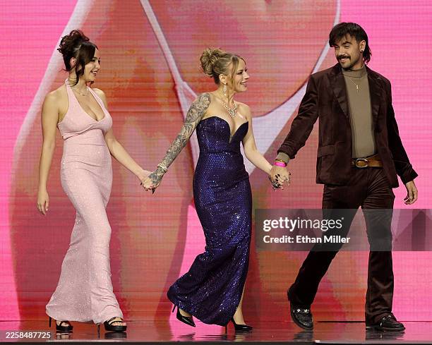 Rissa May, Anna Claire Clouds and Nade Nasty walk onstage to present an award during the 2026 Adult Video News Awards at The Theater at Virgin Hotels...