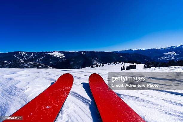 pov red skis at top of scenic mountain - ski slope stock pictures, royalty-free photos & images