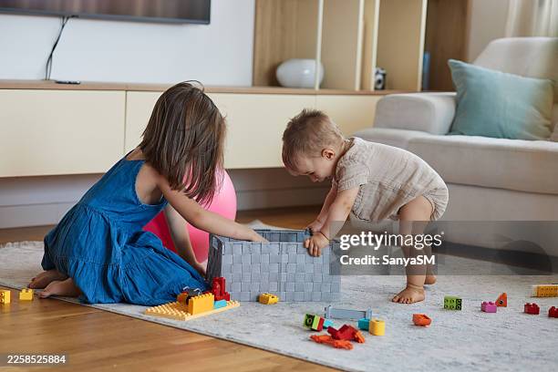 children playing with building blocks in living room - barefoot stock pictures, royalty-free photos & images