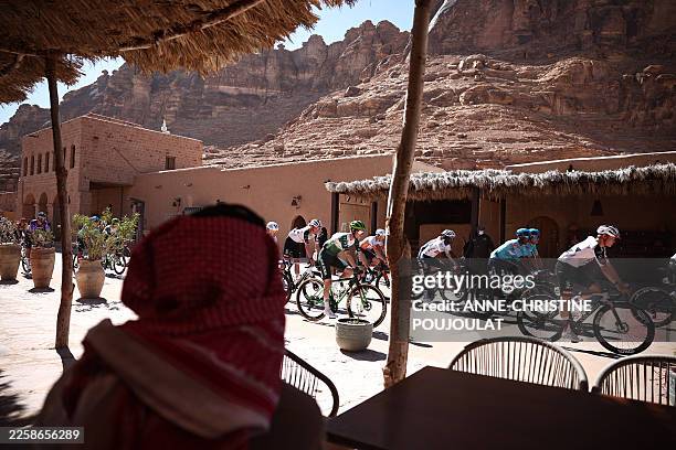 The pack cycles in the fifth and last stage of the AlUla Tour cycling race, 163.9km from Alula Old Town to Skyviews of Harrat Uwayrid on January 31,...