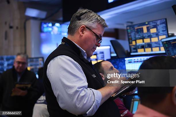 Traders work on the floor of the New York Stock Exchange on January 28, 2026 in New York City. Stocks were down slightly in morning trading.