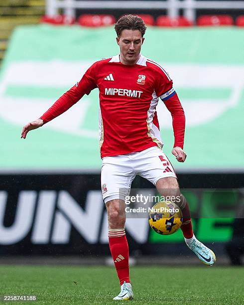 Will Wright of Swindon Town is in action with the ball during the Sky Bet League 2 match between Swindon Town and Barrow at the County Ground in...