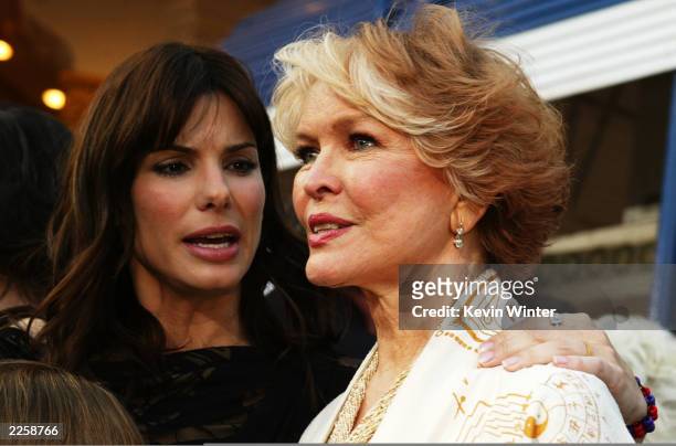 Sandra Bullock chats with Ellen Burstyn as they arrive for the premiere of Divine Secrets Of The Ya-Ya Sisterhood at the Mann Village Theater in Los...