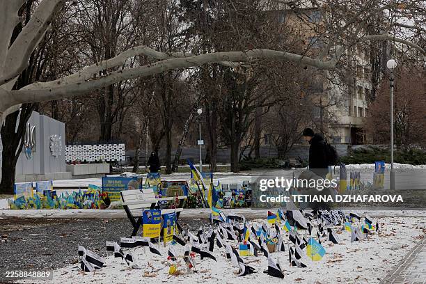 Local residents stand near a memorial for Ukrainian soldiers in Zaporizhzhia on February 1 amid the Russian invasion of Ukraine.
