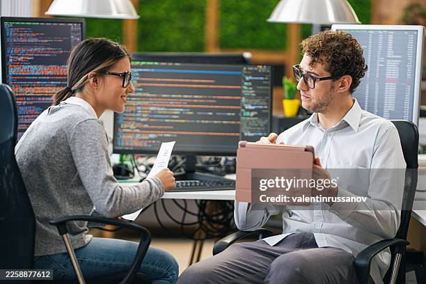 software engineers coding and collaborating in modern office - hackathon stock pictures, royalty-free photos & images