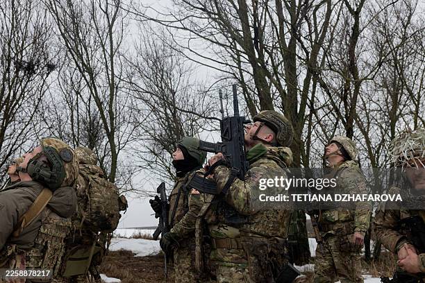 Ukrainian servicemen of the 33rd seperate assault regiment look up at the training drone during a training at an undisclosed location in Zaporizhzhia...