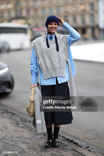 Hollie Mercedes Peters is seen wearing a knitted wool vest with a V neck and side tie details from CLÒIMH; a light blue cotton button up blouse; a...