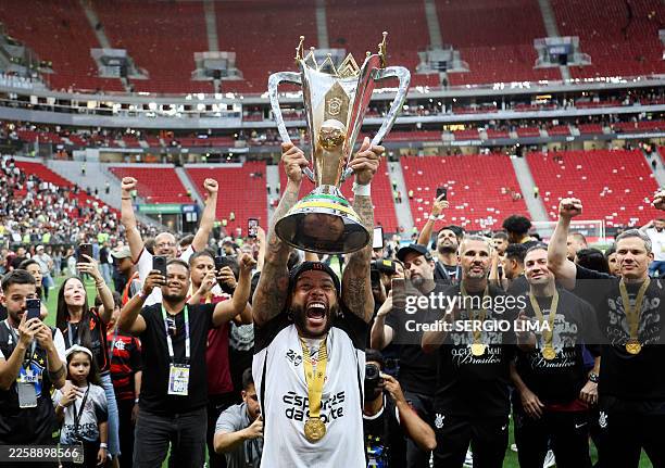 Corinthians' Dutch forward Memphis Depay celebrates with the trophy after winning the Supercopa do Brasil 2026 final football match between Flamengo...