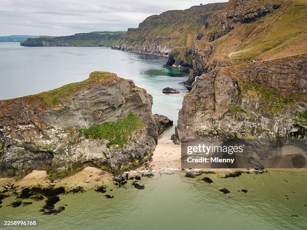 cliffs with carrick a rede rope bridge on northern ireland coast - rocky coastline stock pictures, royalty-free photos & images