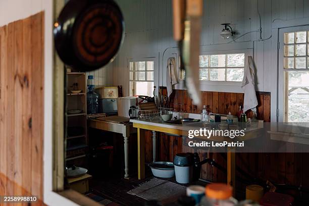 quiet morning inside a rustic kitchen - rustic cabin stock pictures, royalty-free photos & images
