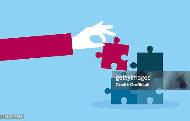 hand placing missing puzzle piece to complete business strategy and teamwork concept - integrated marketing strategy stock illustrations