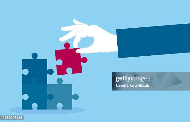 human hand placing the final jigsaw piece to ensure strategic integrity and complete project - integrated solutions stock illustrations