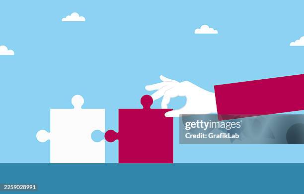 human hand placing the missing jigsaw piece for strategic solution and completion - integrated solutions stock illustrations