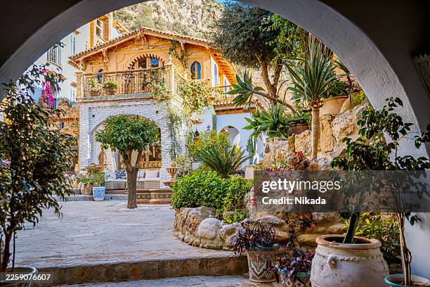 charming moroccan courtyard with lush plants - earthenware stock pictures, royalty-free photos & images