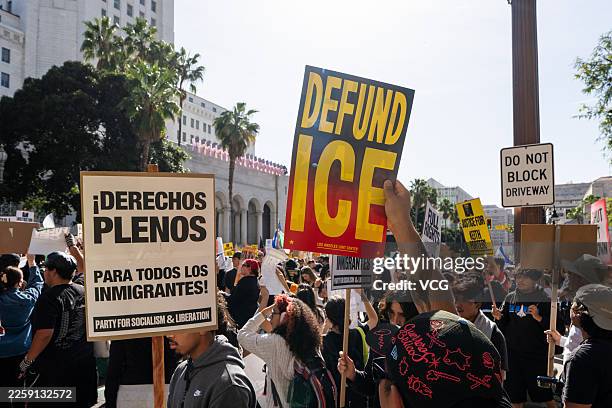 People gather outside Los Angeles City Hall partake in a "National Shutdown" protest against US Immigration and Customs Enforcement on January 30,...