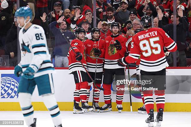 Sam Rinzel of the Chicago Blackhawks celebrates scoring with his teammates during the second period against the San Jose Sharks at the United Center...